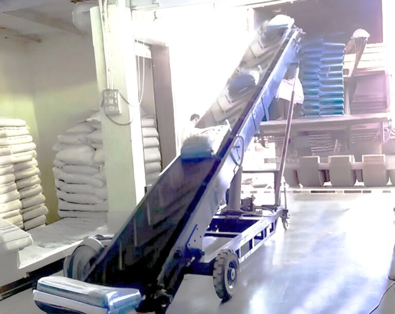 Portable truck loading conveyor loading bags into truck